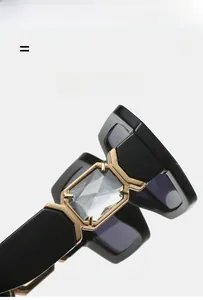Detail of square crystal inlay on black and gold lightweight temples of trendy sunglasses