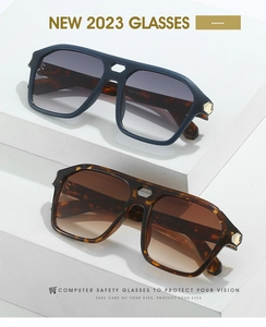 Detail of double-bridge oversized sunglasses with tortoiseshell frames on a stone stand