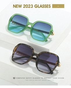 Detail view of large square sunglasses in mint green and tortoiseshell with gradient lenses