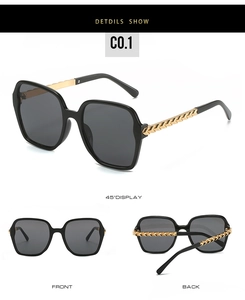 Detail shot of oversized square sunglasses featuring elegant gold chain-link metal temples