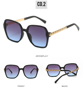 Detail view of large square sunglasses with gold textured temples and gradient blue lenses