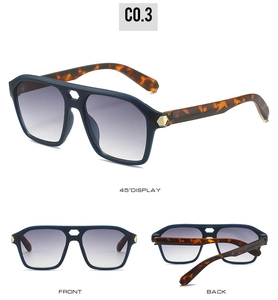 Detail view of double bridge sunglasses with tortoise temples and gradient lenses