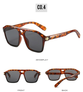 Detail view of tortoiseshell double-bridge sunglasses with gold hexagonal temple accents