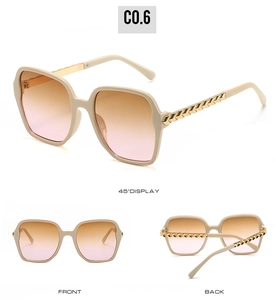 Detail view of cream square sunglasses with gold metal chain temples and gradient lenses