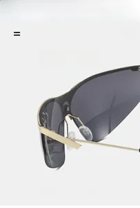 Close-up of lightweight gold metal half-frame cycling sunglasses with grey lenses