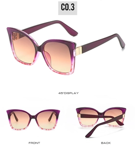 Cat eye sunglasses featuring purple gradient lenses and gold metallic temple details