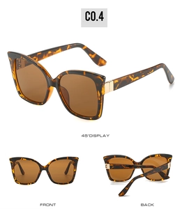 Detailed views of tortoise shell cat-eye sunglasses with gold metal hinges and brown lenses