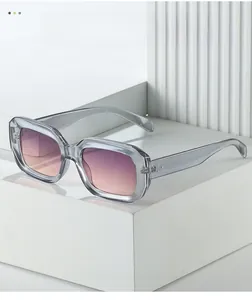 Macro view of transparent grey square sunglasses with gradient lenses and rivet details