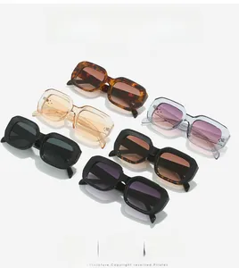 Flat lay of stylish rectangular sunglasses in various colors with bold frames and rivets