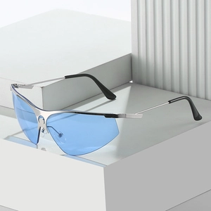 Futuristic silver half-frame cycling sunglasses with sky blue lenses on white blocks