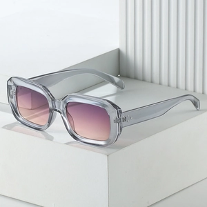 Square frame sunglasses with grey transparent frames and gradient lenses featuring metal rivets