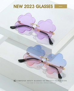 Macro view of rimless flower sunglasses featuring petal edge cutting and gold temples