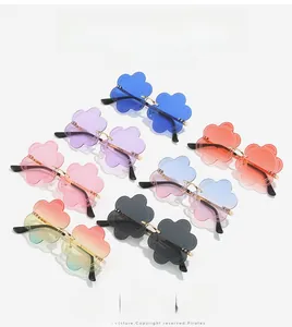 Macro detail of rimless flower-shaped sunglasses with metal frame in multiple colors