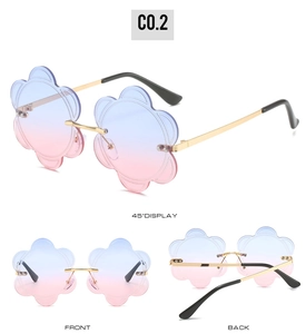 Detailed views of rimless flower sunglasses with blue-pink gradient lenses and gold temples