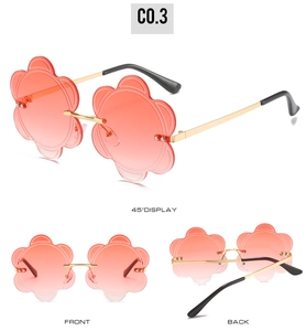 Detail view of flower shaped rimless sunglasses with pink gradient lenses and metal frame