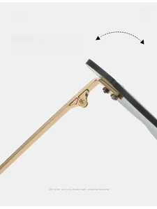 Detail of durable gold metal hinge on rimless sunflower sunglasses with grey lenses