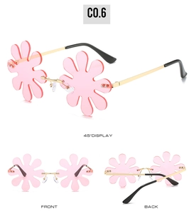 Detailed views of rimless flower-shaped pink sunglasses with gold metal frame