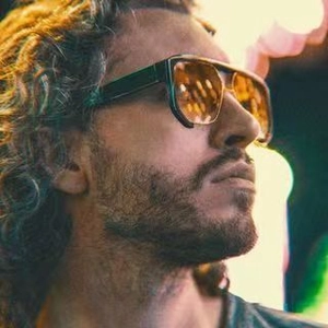 Side view of punk hip-hop sunglasses with thick dark frames and orange lenses