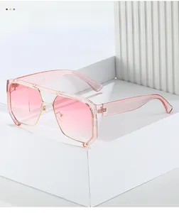 Detail of pink gradient lenses and gold metal frames on large punk oversized sunglasses