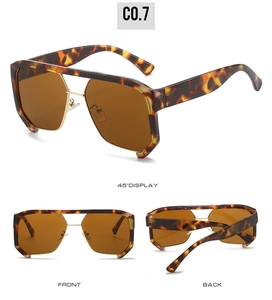 Detail view of tortoiseshell oversized sunglasses featuring gold metal nose bridge accents