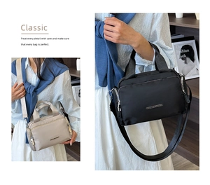 Detail of multi-pocket nylon tote bags with metal logo and adjustable wide straps