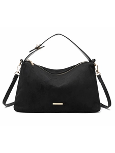 Detailed view of black faux suede shoulder bag with gold zipper and metal hardware