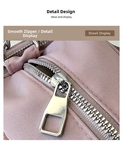 Detail of a smooth silver zipper and pink nylon fabric on a large commuter tote bag