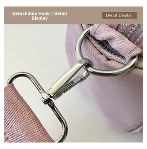 Close-up of shiny silver metal detachable hook and pink woven strap on tote bag