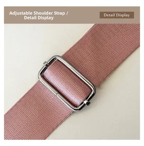 Detail view of adjustable strap with metallic buckle on purple nylon tote bag