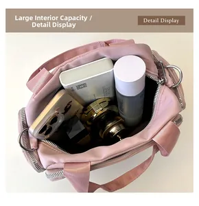 Detailed interior of the pink nylon tote bag showing spacious multi-pocket storage