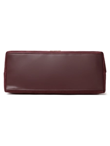 Detail of burgundy faux suede and smooth leather base with precision stitching on tote bag