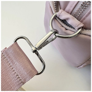 Detail of silver swivel hook and purple nylon strap on a stylish commuter tote bag