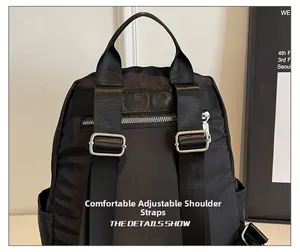 Detail of adjustable padded straps and anti-theft back zipper on black nylon backpack