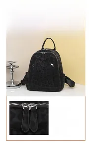 Detail of black leopard print backpack featuring smooth zippers and adjustable straps