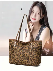 Detailed view of large leopard print tote bag with faux leather straps on a model