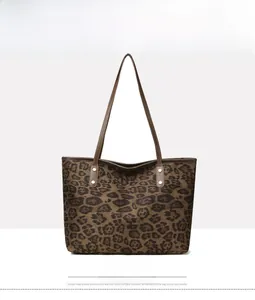 Front view of leopard print tote bag in coffee brown with leather straps and rivets