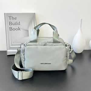 Green nylon tote bag with GENTLEWOMAN logo and adjustable wide shoulder strap