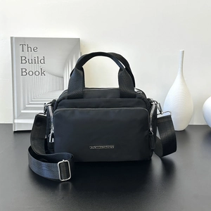 Large black multi-pocket nylon tote bag with GENTLEWOMAN logo and adjustable wide strap