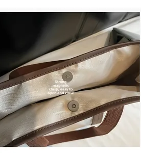 Détail du grand sac cabas en toile montrant la boucle magnétique et la doublure beige