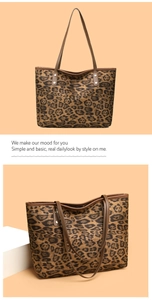 Detail view of large leopard print tote bag featuring sturdy brown straps and metal rivets