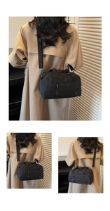 Detail showing various wearing styles of the large capacity black nylon tote with shoulder strap