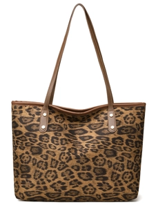 Detailed close-up of brown leopard print tote bag with leather handles and metal rivets