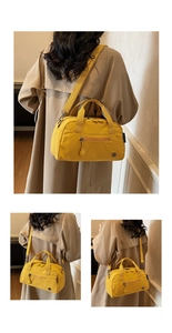 Detail view of yellow nylon tote bag showing front zipper pocket and side branding label