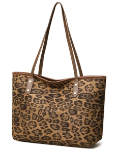 Close-up of leopard print tote bag with brown leather handles and side rivet details