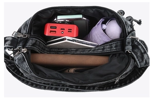 Detail view of large capacity denim crossbody bag interior with multiple compartments