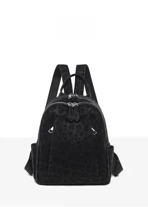 Front view of leopard print backpack with dual zippers and mesh side pockets