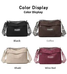 Detailed view of casual nylon crossbody bag showing three zipper compartments and wide strap