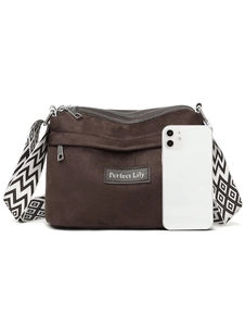 Detail of dark brown matte nylon crossbody bag with black and white geometric strap