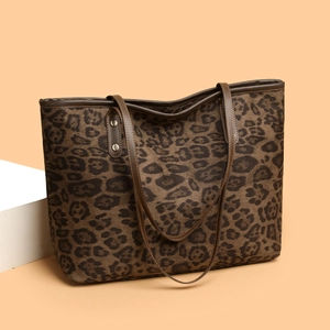 High-capacity leopard print tote bag with brown leather handles and silver rivet details
