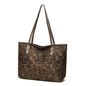 Large leopard print tote bag with brown leather handles and gold rivets on white background